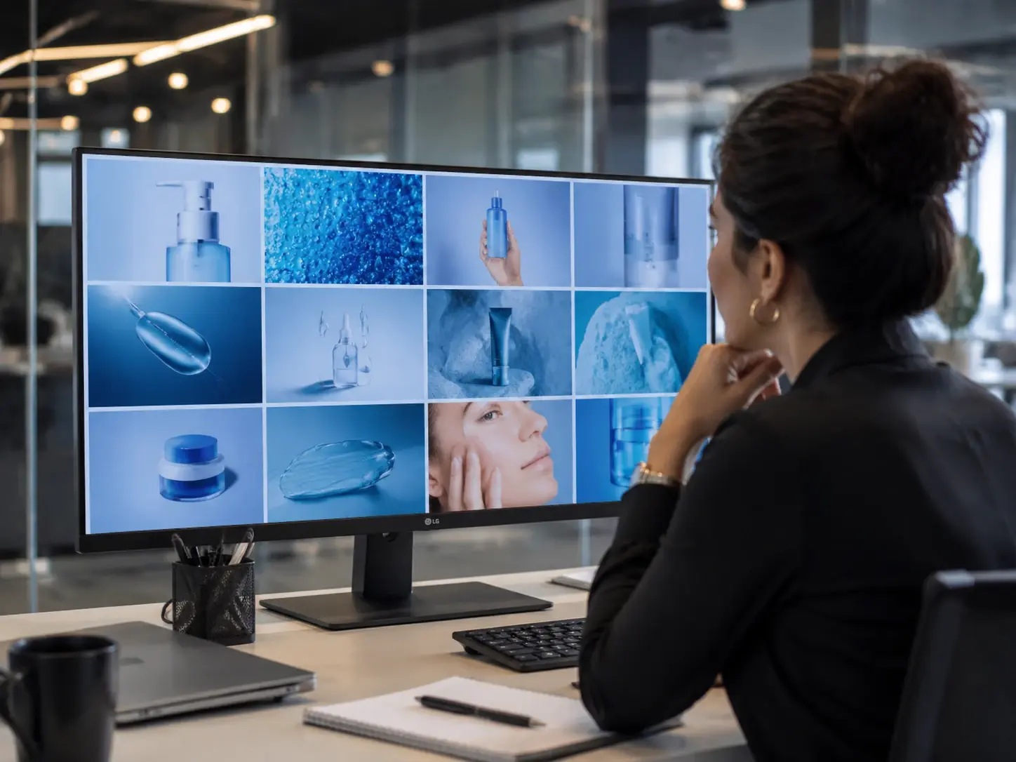Brand content lead reviewing campaign frames from the AI image generator on a wide screen